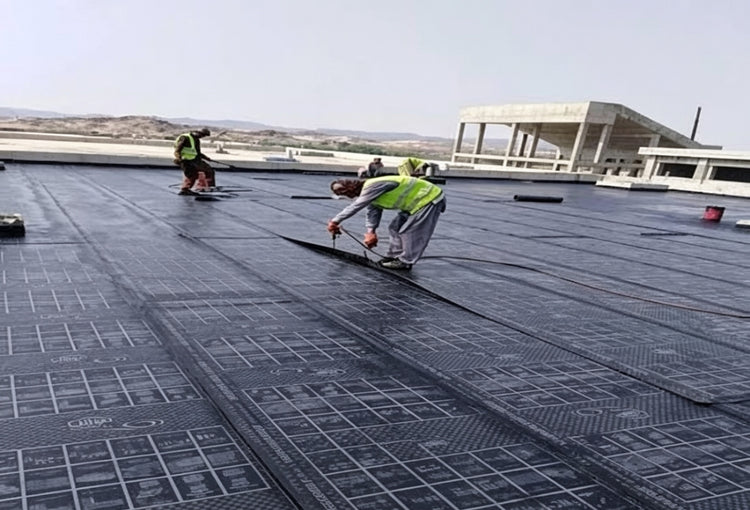 فريق برايت وولز إنترناشونال يركّب لفائف العزل المائي البيتوميني على سطح مبنى تجاري